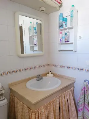 a bathroom with a sink and a mirror at Apartamento Ailem in Novo Sancti Petri
