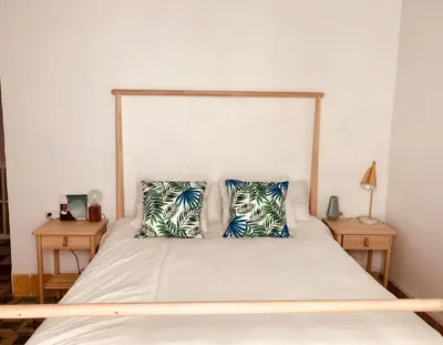 a bedroom with a bed with two pillows on it at APARTAMENTO LA MODERNA in Cádiz