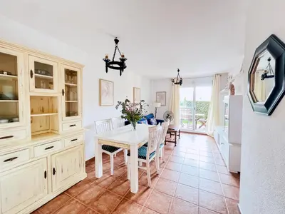 a kitchen and dining room with a table and chairs at Jardín del Golf Nº 36 by Fontanilla del Mar Holidays Rentals in Chiclana de la Frontera