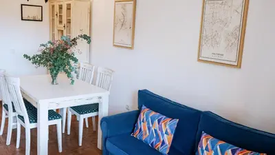 a living room with a blue couch and a table at Jardín del Golf Nº 36 by Fontanilla del Mar Holidays Rentals in Chiclana de la Frontera