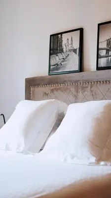 a bedroom with a bed with two pictures on the wall at Jardín del Golf Nº 36 by Fontanilla del Mar Holidays Rentals in Chiclana de la Frontera