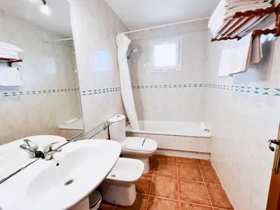 a white bathroom with a sink and a toilet at Jardín del Golf Nº 36 by Fontanilla del Mar Holidays Rentals in Chiclana de la Frontera