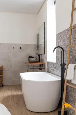 a large white tub in a bathroom with a sink at Tiles Home by Cadiz Time in Cádiz