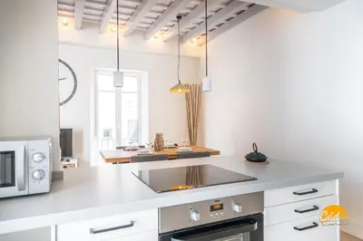 a kitchen with a white counter and a microwave at Tiles Home by Cadiz Time in Cádiz