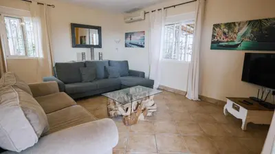a living room with a couch and a table at Casa Rural Los Garrovillos by Fontanilla del Mar Holidays Rentals in Conil de la Frontera