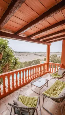 a balcony with chairs and a view of the beach at Casa Rural Los Garrovillos by Fontanilla del Mar Holidays Rentals in Conil de la Frontera
