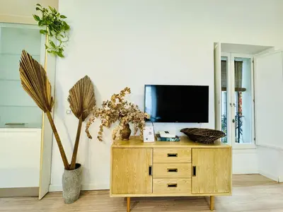 a living room with a tv on a wooden cabinet at MANA home Keep calm feel the light and shine in Cádiz