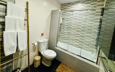 a bathroom with a toilet and a glass shower at MANA home Keep calm feel the light and shine in Cádiz