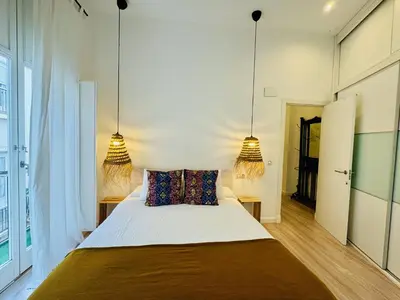 a bedroom with a large bed with two lamps at MANA home Keep calm feel the light and shine in Cádiz