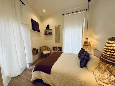 a bedroom with a large bed and a window at MANA home Keep calm feel the light and shine in Cádiz