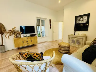 a living room with a couch and a tv at MANA home Keep calm feel the light and shine in Cádiz
