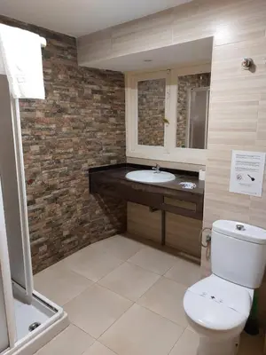 a bathroom with a white toilet and a sink at La Casona de Rances Grupo AC Gestion in Cádiz