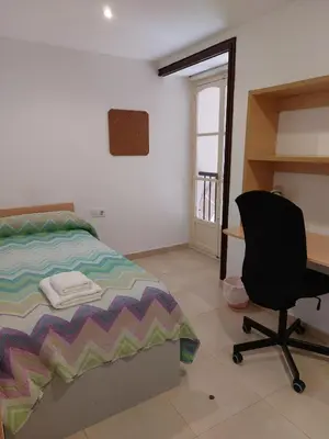 a bedroom with a bed and a desk and a chair at La Casona de Rances Grupo AC Gestion in Cádiz