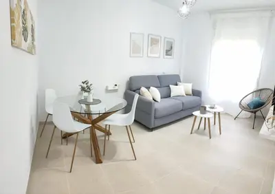 a living room with a couch and a table at RELAX CHICLANA-Aparcamiento privado-TV Cable-WifiPlus-Aire Acond-Incluido in Chiclana de la Frontera