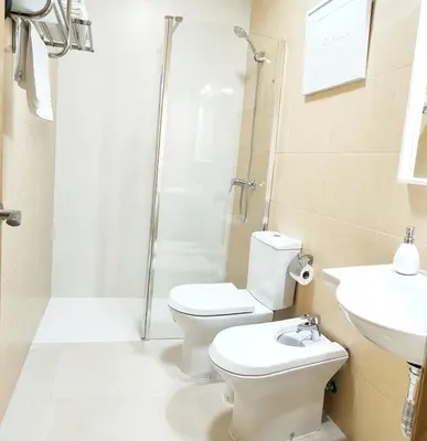 a bathroom with a toilet and a shower and a sink at RELAX CHICLANA-Aparcamiento privado-TV Cable-WifiPlus-Aire Acond-Incluido in Chiclana de la Frontera