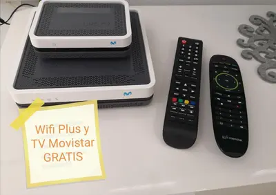 two remote controls and a tv controller on a table at RELAX CHICLANA-Aparcamiento privado-TV Cable-WifiPlus-Aire Acond-Incluido in Chiclana de la Frontera