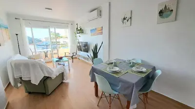 a dining room with a table and chairs in a room at Apartamento Playa La Barrosa in Chiclana de la Frontera