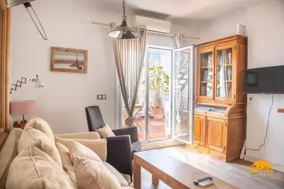 a living room with a couch and a table at La Bella Escondida by Cadiz Time in Cádiz
