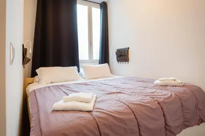 a bed with two white towels on top of it at Atico & Jacuzzi CRUZ by Cadiz4Rentals in Cádiz