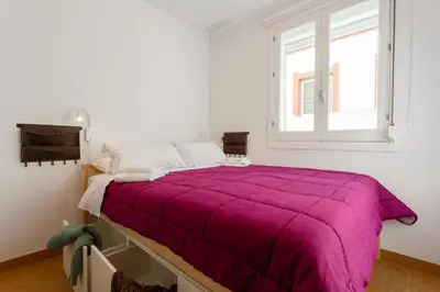 a white bedroom with a large bed with a purple blanket at Atico & Jacuzzi CRUZ by Cadiz4Rentals in Cádiz