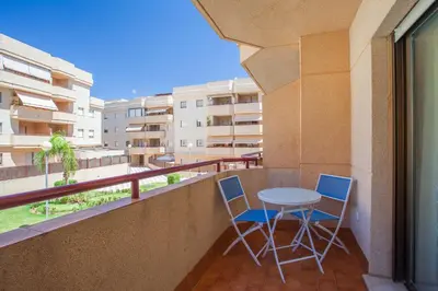 a balcony with two chairs and a table at APARTAMENTO CENTRO JARDINES TEMPUL in Jerez de la Frontera