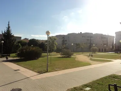 a street light in a park with buildings in the background at APARTAMENTO CENTRO JARDINES TEMPUL in Jerez de la Frontera