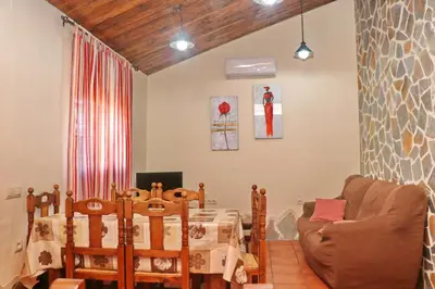 a dining room with a table and a chair and a table and a table at Chalet Bella Mendoza in Conil de la Frontera