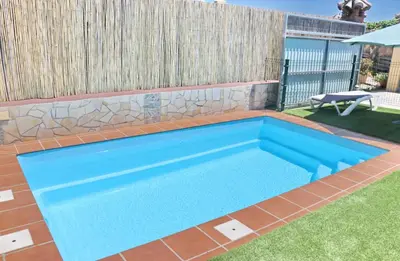 a swimming pool in a backyard with a fence at Chalet Bella Mendoza in Conil de la Frontera