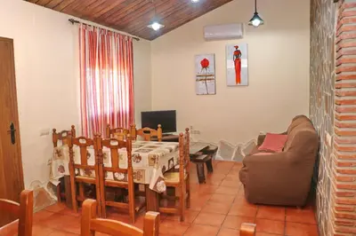 a living room with a table and a couch at Chalet Bella Mendoza in Conil de la Frontera