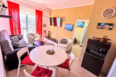 a living room with a table and a couch at En Playa Apartamento con Balcón, Wifi in El Puerto de Santa María