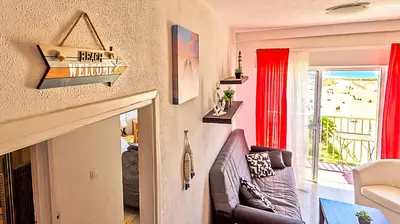 a living room with a couch and a view of the ocean at En Playa Apartamento con Balcón, Wifi in El Puerto de Santa María