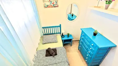 a room with a blue dresser and a blue bench at En Playa Apartamento con Balcón, Wifi in El Puerto de Santa María