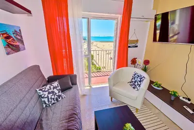 a living room with a couch and a view of the ocean at En Playa Apartamento con Balcón, Wifi in El Puerto de Santa María