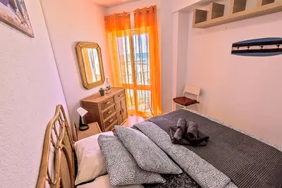 a bedroom with a bed with a stuffed animal on it at En Playa Apartamento con Balcón, Wifi in El Puerto de Santa María