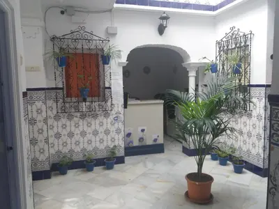 a room with potted plants and a red door at Hospederia Islasol in San Fernando