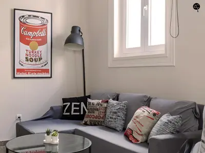 a living room with a blue couch with pillows and a table at Cadiz Cinema Grupo AC Gestion in Cádiz