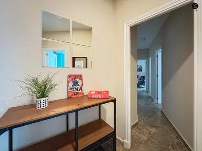 a hallway with a table and a mirror at Cadiz Cinema Grupo AC Gestion in Cádiz