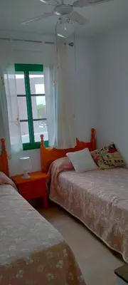 a bedroom with two beds and a window at Primera linea de playa 
