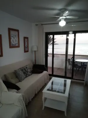 a living room with a couch and a table at Primera linea de playa 