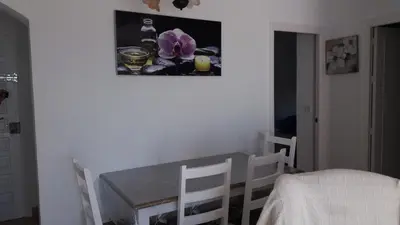 a table and chairs in a room with a picture on the wall at Primera linea de playa 