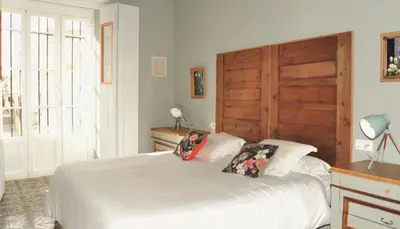 a bedroom with a bed with a backpack on it at Casa de Lys in Sanlúcar de Barrameda