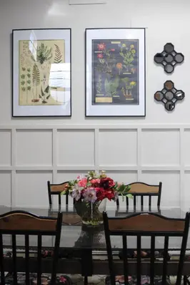 a dining room table with a vase of flowers on it at Casa de Lys in Sanlúcar de Barrameda