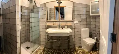 a bathroom with a sink and a toilet at Casa de Lys in Sanlúcar de Barrameda