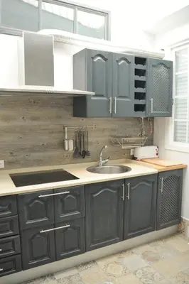 a kitchen with gray cabinets and a sink at Casa de Lys in Sanlúcar de Barrameda