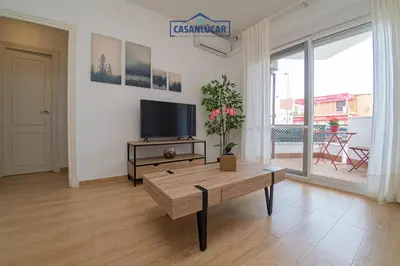 a living room with a tv and a coffee table at Parque Doñana in Sanlúcar de Barrameda