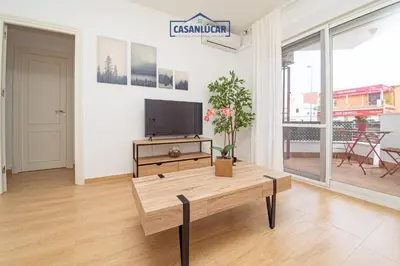 a living room with a tv and a coffee table at Parque Doñana in Sanlúcar de Barrameda