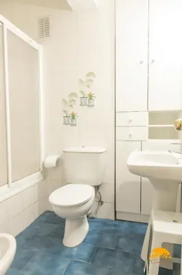 a white bathroom with a toilet and a sink at Villa Lola by Cadiz Time in Cádiz