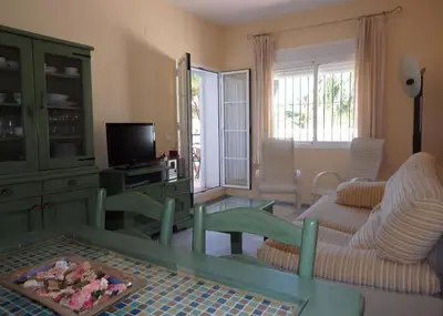 a living room with a couch and a table at Apartamento la Barrosa ,Urb los Veleros in Chiclana de la Frontera