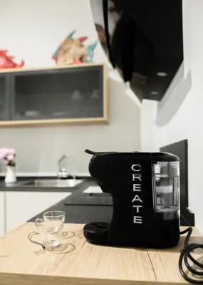a black coffee maker sitting on a table in a kitchen at innCádizCASA SEÑORIAL DE 1790 in Cádiz