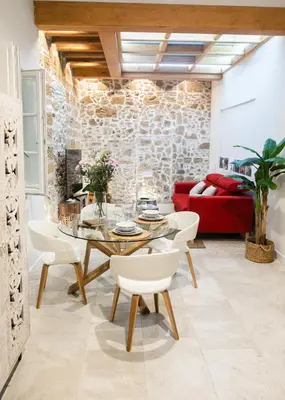 a living room with a table and a red couch at innCádizCASA SEÑORIAL DE 1790 in Cádiz